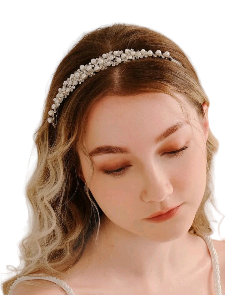 A bridal headband adorned with rhinestones and faux pearls, creating an exquisite and elegant accessory that adds a touch of timeless beauty and sophistication to a bride's ensemble.