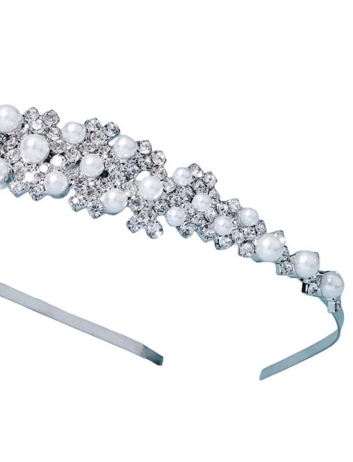 A bridal headband adorned with rhinestones and faux pearls, creating an exquisite and elegant accessory that adds a touch of timeless beauty and sophistication to a bride's ensemble.