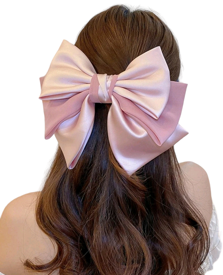 A fashionable pink hair clip embellished with a charming bow design. This delightful hair accessory adds a touch of style and whimsy to your look, making it a perfect choice for elevating your hairstyle with a playful and trendy accent.