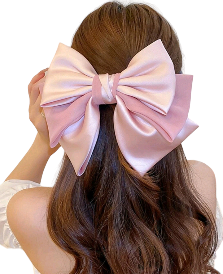 A fashionable pink hair clip embellished with a charming bow design. This delightful hair accessory adds a touch of style and whimsy to your look, making it a perfect choice for elevating your hairstyle with a playful and trendy accent.