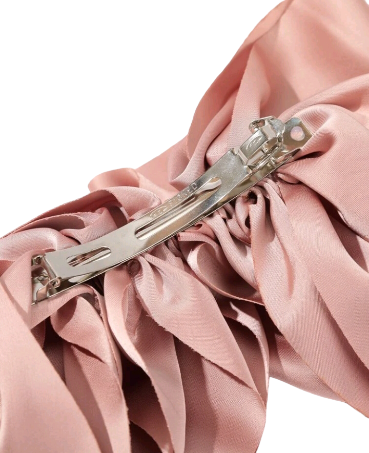 A lovely pink bow decorated hair clip, adding a touch of sweetness and elegance to your hairstyle. This chic accessory is perfect for enhancing your look with a charming and stylish detail.