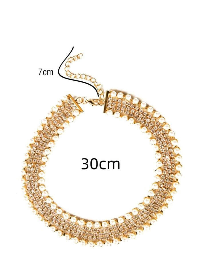 Glamorous rhinestone and faux pearl decorated necklace, featuring a dazzling combination of sparkling rhinestones and lustrous faux pearls. This exquisite necklace adds a touch of opulence and sophistication to any attire, making it a stunning statement piece for special occasions.