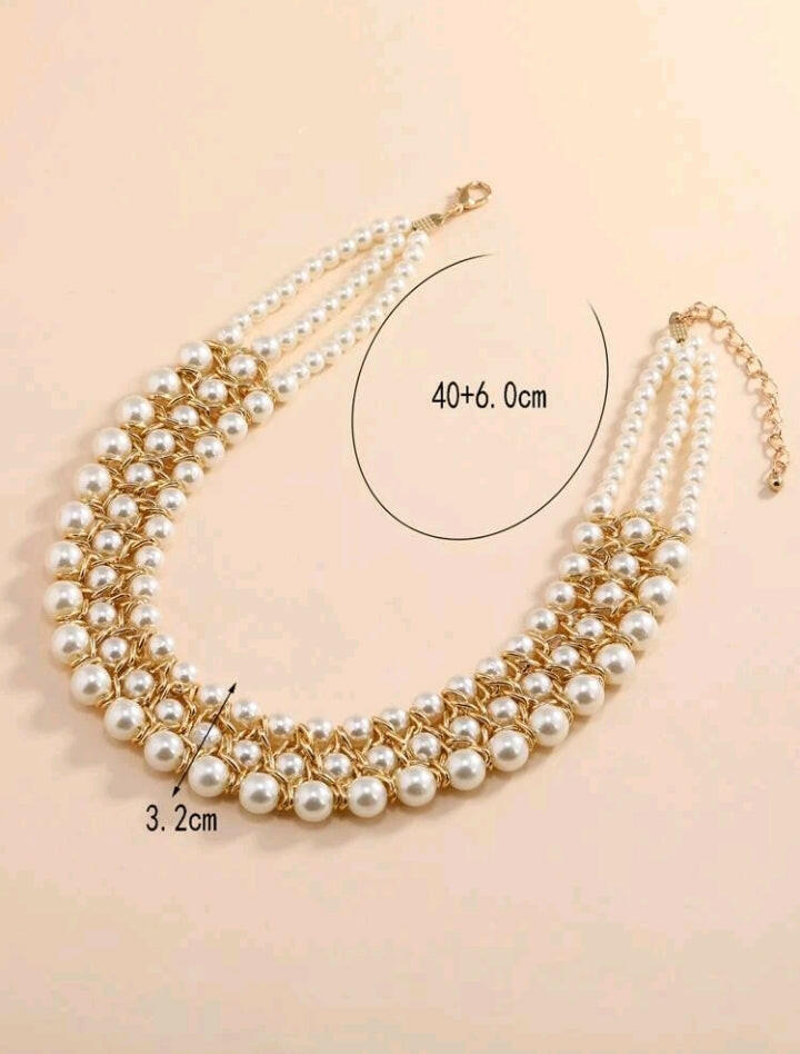 Image of a faux pearl beaded layered necklace, featuring multiple strands of lustrous pearl-like beads elegantly arranged, creating a sophisticated and timeless accessory for any outfit or occasion.