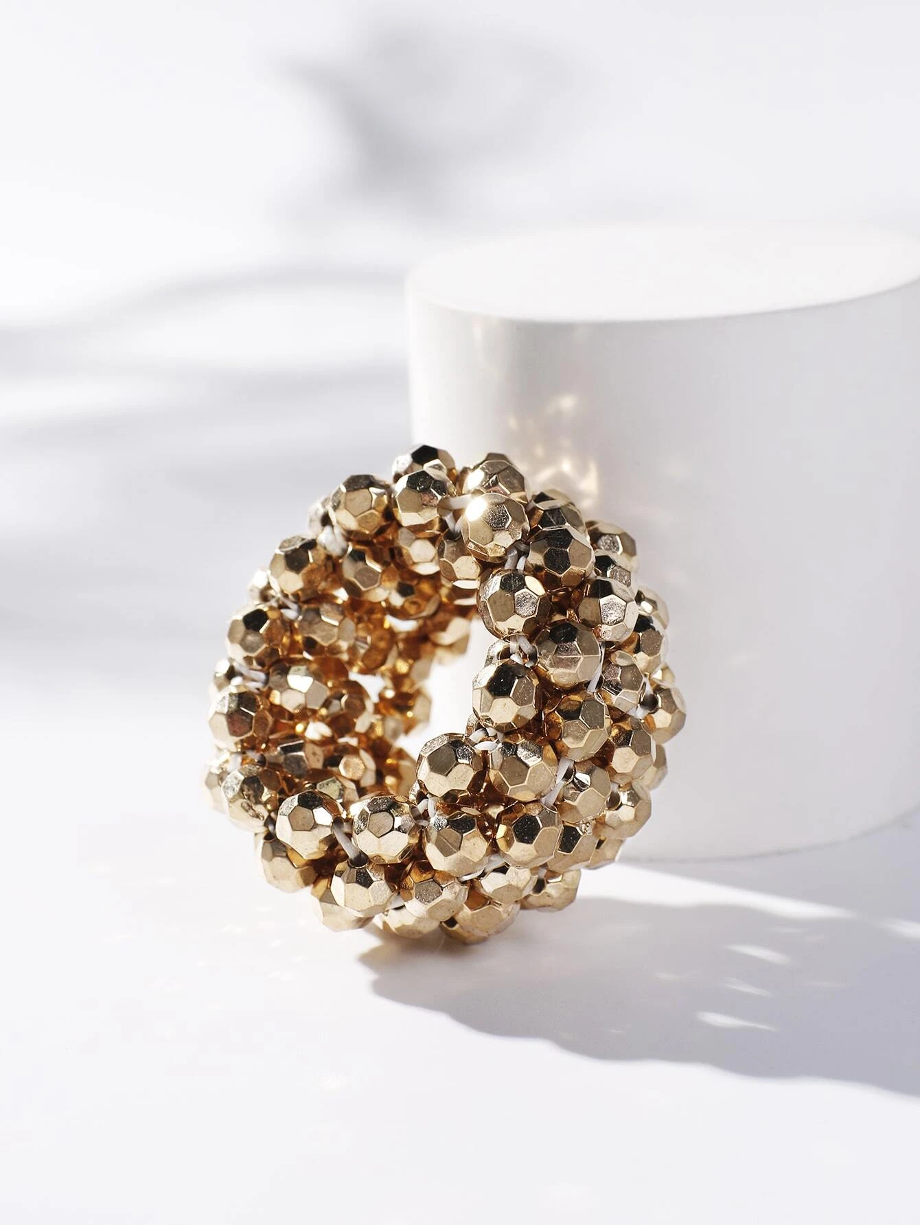 A hair tie adorned with beads, providing a unique and stylish way to secure and adorn your hair.