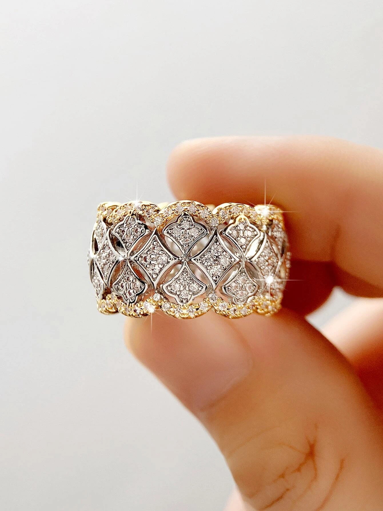 A stunning cubic zirconia decor ring with intricate details. The ring showcases a brilliant cubic zirconia gemstone set in an elegantly designed setting. The shimmering gemstone creates a captivating and glamorous look. This ring is a stylish and sophisticated accessory that adds a touch of elegance and luxury to any outfit.