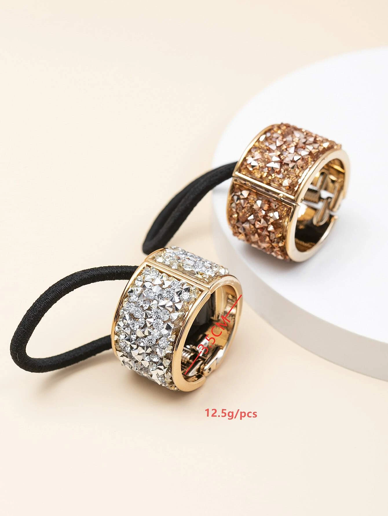 Two hair ties embellished with dazzling rhinestone decorations, perfect for adding a touch of sparkle and style to your hair.