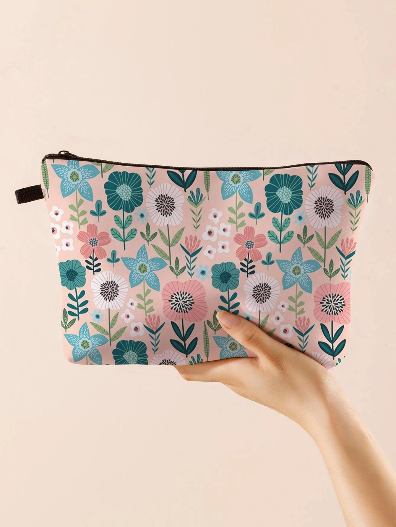 Makeup bag with a charming flower print and zipper closure. This accessory offers a blend of style and practicality, perfect for storing and carrying your cosmetics in a trendy and organized manner.