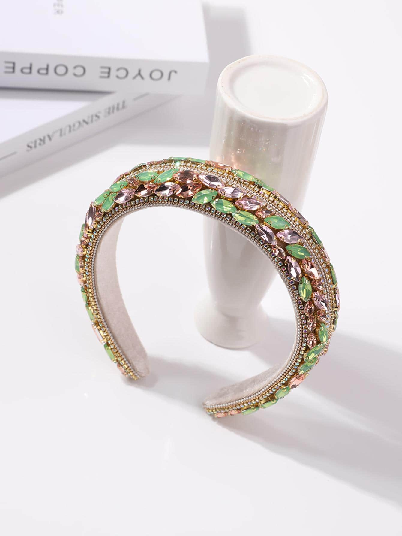 Glamorous headband adorned with green rhinestone decorations, adding a touch of elegance and sparkle to your hair accessory.