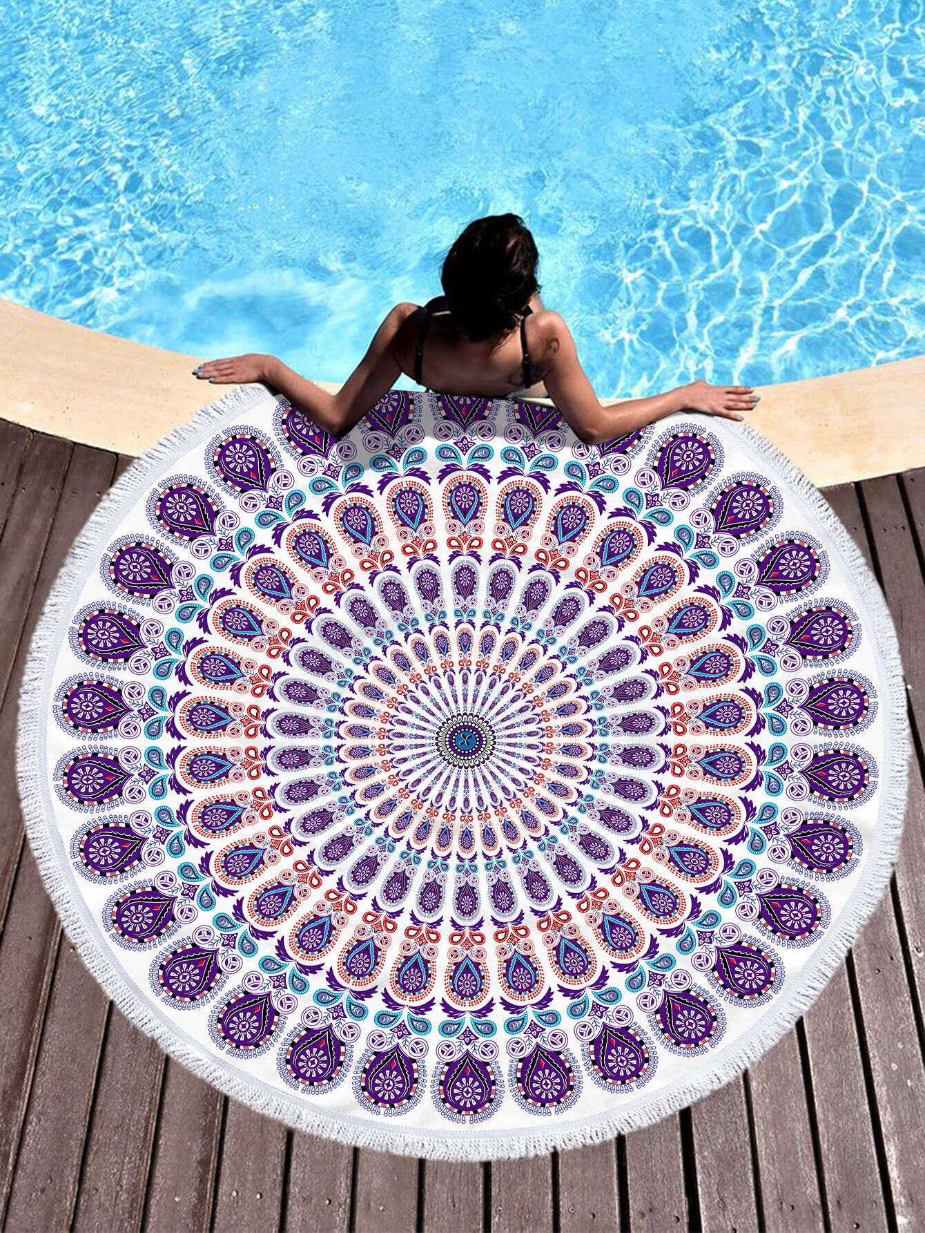 A beach towel featuring a purple mandala pattern and fringe trim. The towel showcases an intricate mandala design in shades of purple, with decorative fringe trim along the edges. This towel is both stylish and functional, perfect for beach outings or outdoor relaxation. The purple mandala pattern and fringe trim add a touch of bohemian elegance to the towel.