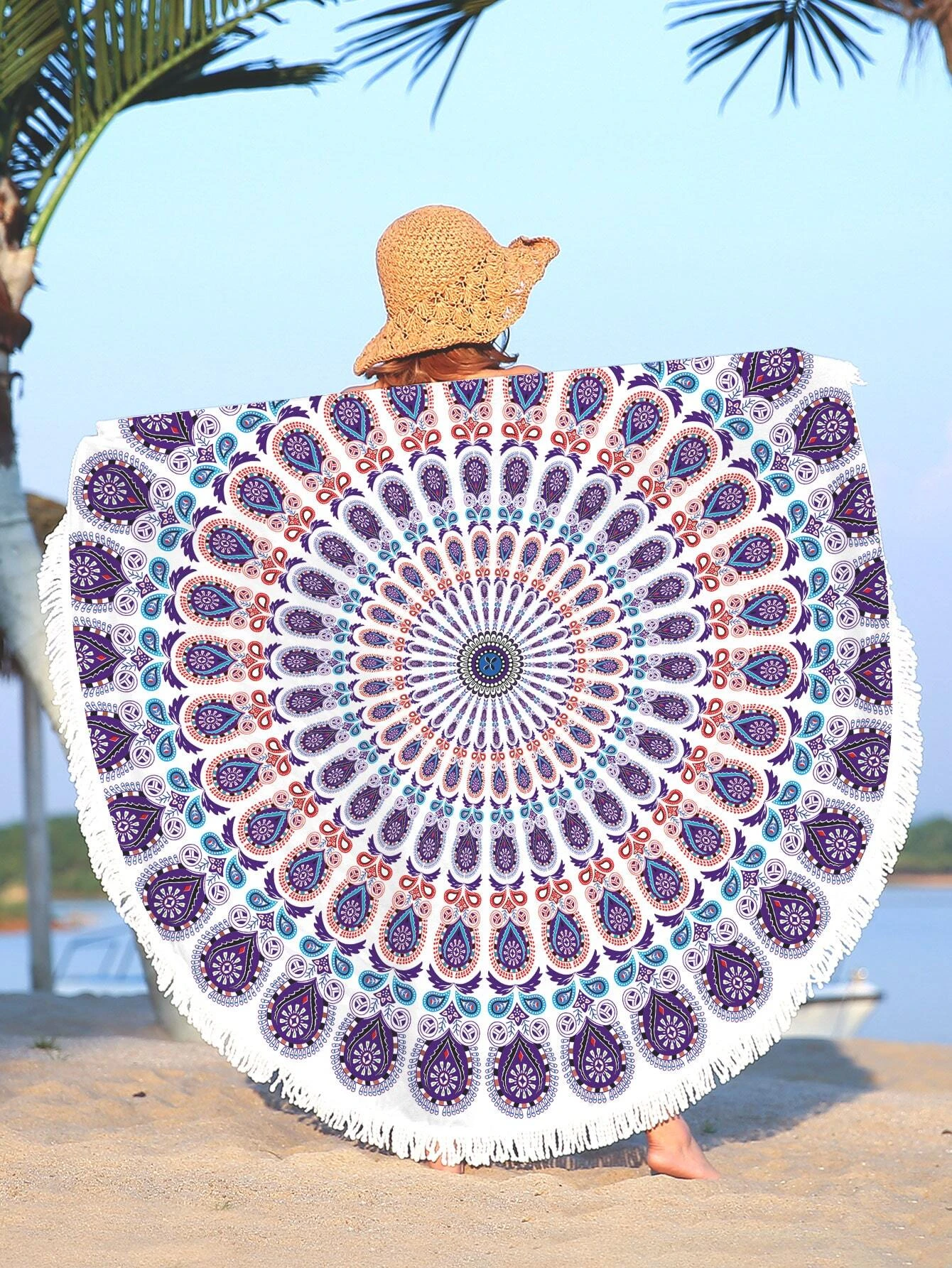 A beach towel featuring a purple mandala pattern and fringe trim. The towel showcases an intricate mandala design in shades of purple, with decorative fringe trim along the edges. This towel is both stylish and functional, perfect for beach outings or outdoor relaxation. The purple mandala pattern and fringe trim add a touch of bohemian elegance to the towel.