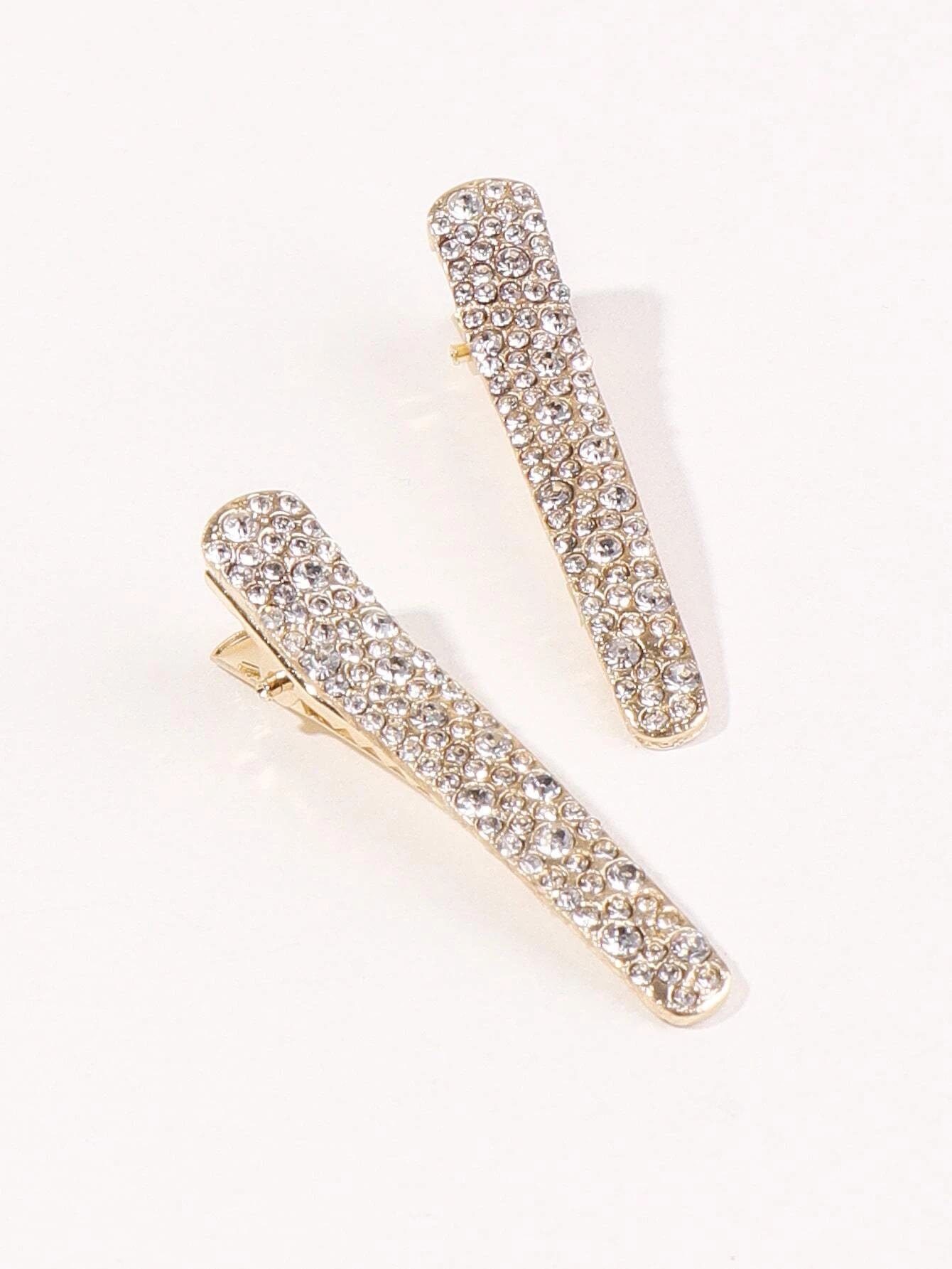 Two hair clips adorned with shimmering rhinestone decorations, adding a touch of elegance and glamour to your hairdo.