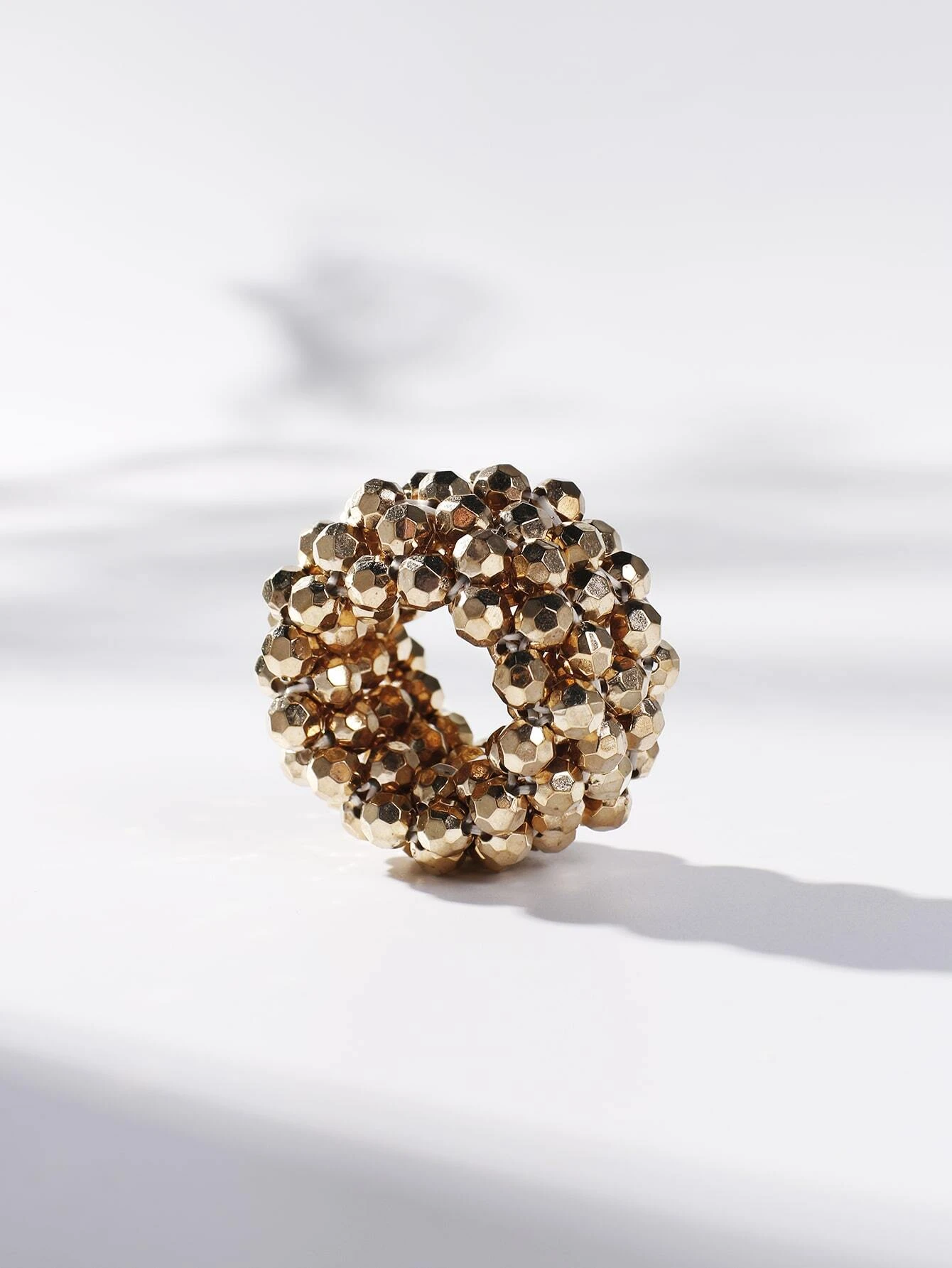 A hair tie adorned with beads, providing a unique and stylish way to secure and adorn your hair.