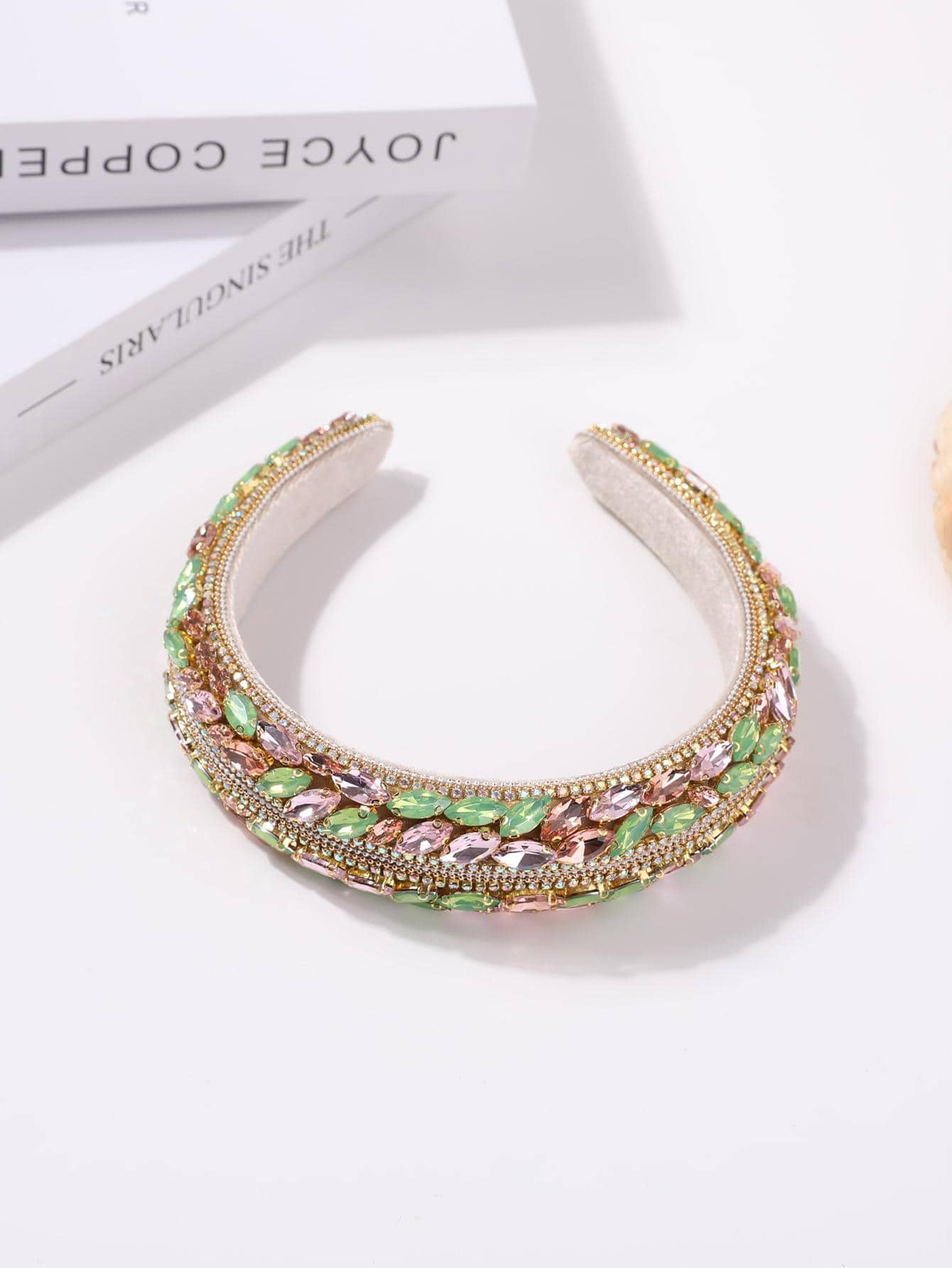 Glamorous headband adorned with green rhinestone decorations, adding a touch of elegance and sparkle to your hair accessory.