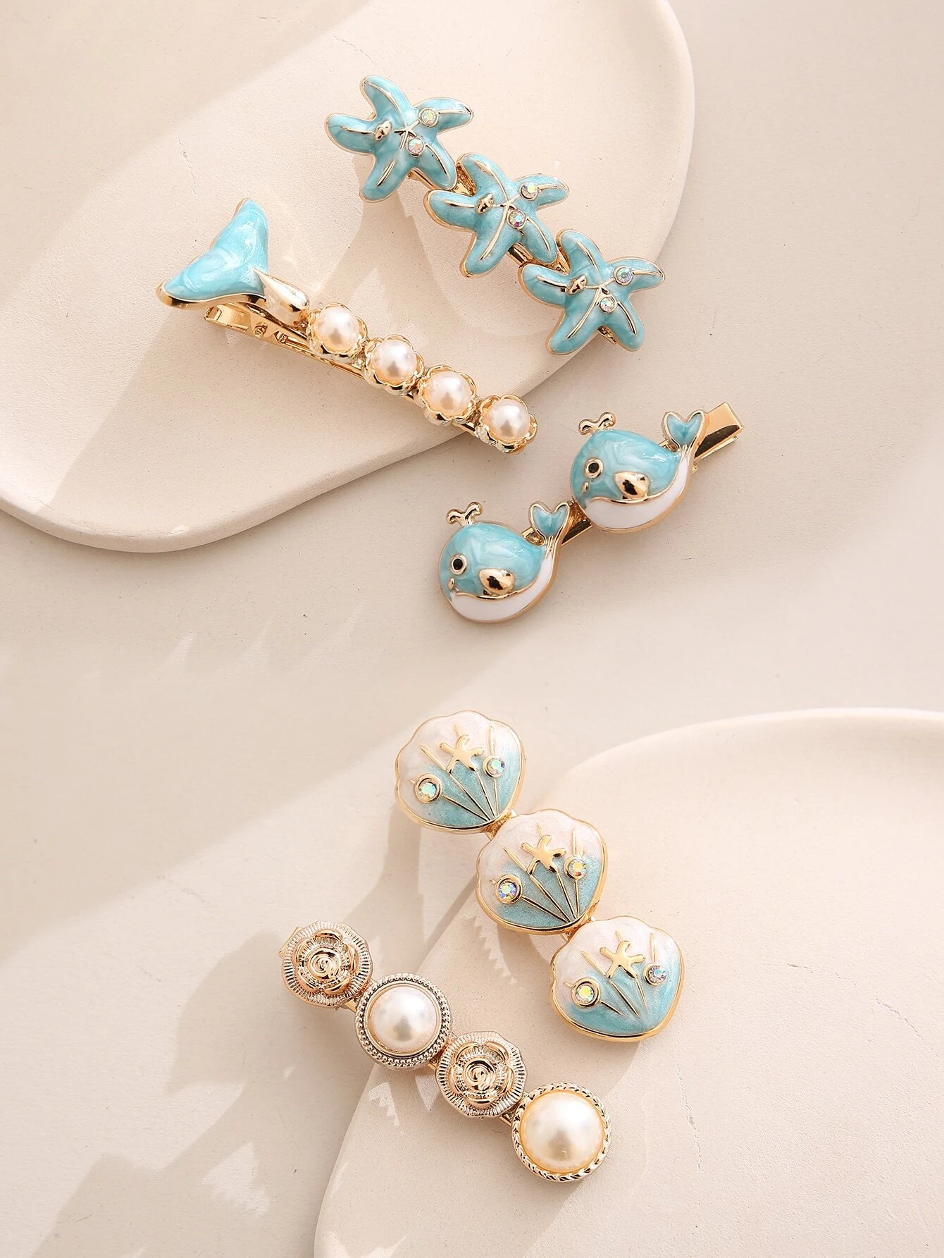 A set of five boho hair clips featuring starfish and shell decorations, adding a beachy and whimsical touch to your hair styling.