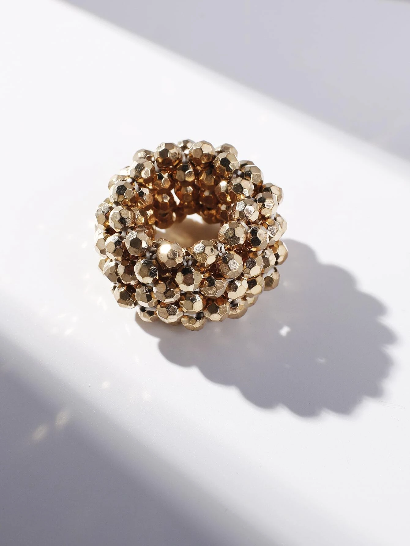 A hair tie adorned with beads, providing a unique and stylish way to secure and adorn your hair.