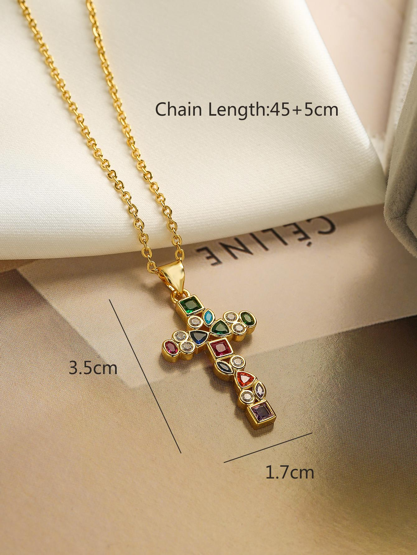 A necklace featuring a colorful cubic zirconia cross charm pendant. The pendant showcases a cross design adorned with vibrant cubic zirconia gemstones in various colors, suspended from a delicate chain. This necklace is both eye-catching and symbolic, adding a touch of elegance and spiritual significance to different outfits.