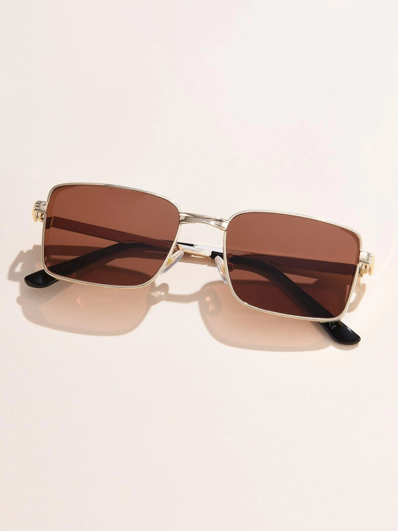 Pair of Tinted Lens Sunglasses with a fashionable and practical design. These sunglasses feature lenses with a tinted shade, combining style and sun protection for a versatile eyewear choice.