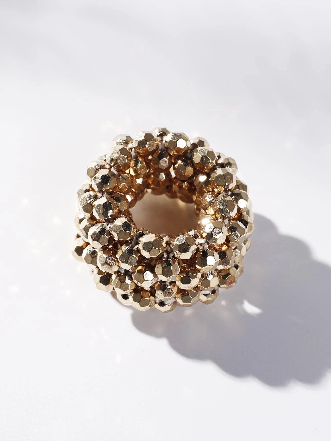 A hair tie adorned with beads, providing a unique and stylish way to secure and adorn your hair.