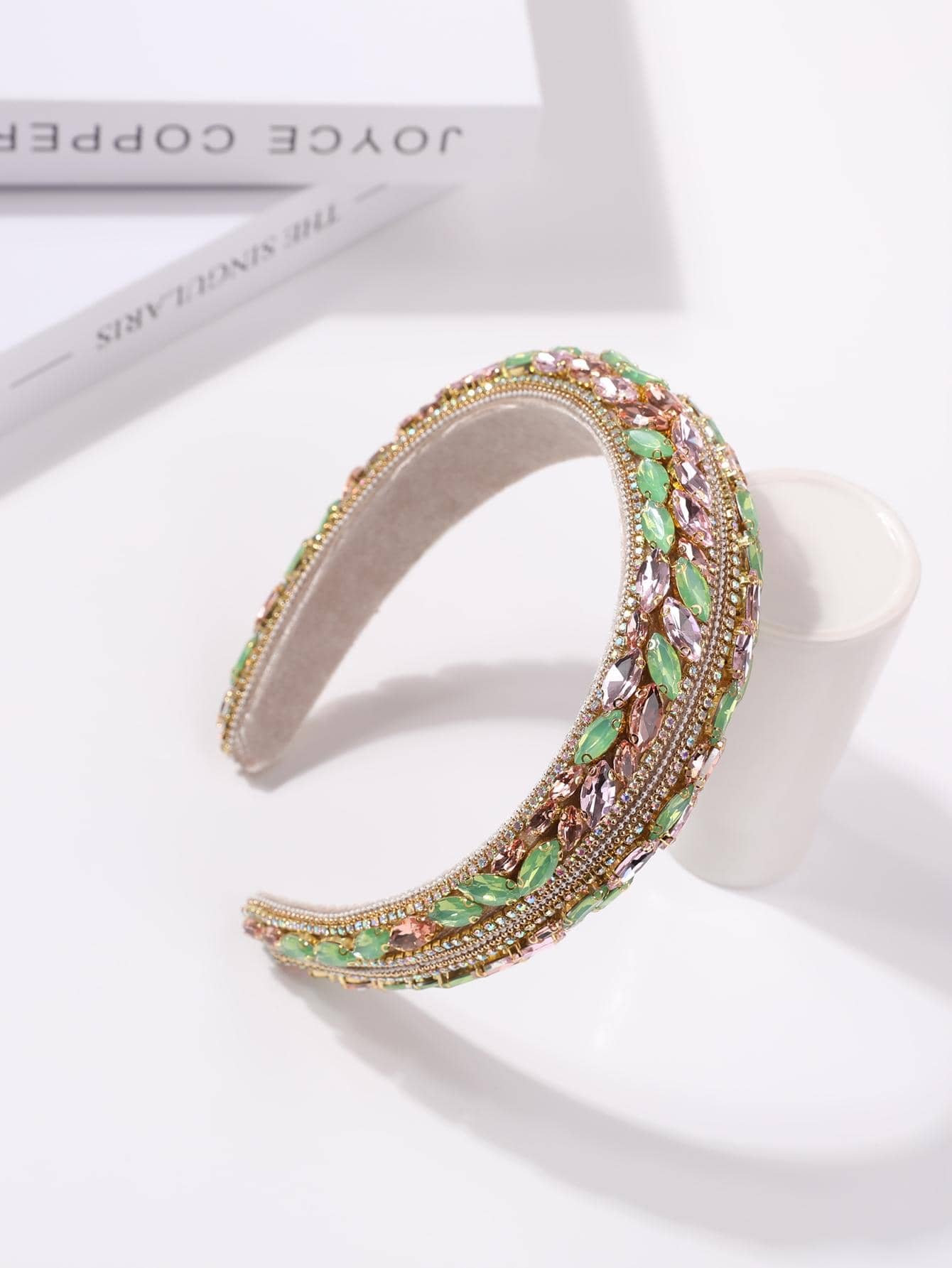 Glamorous headband adorned with green rhinestone decorations, adding a touch of elegance and sparkle to your hair accessory.