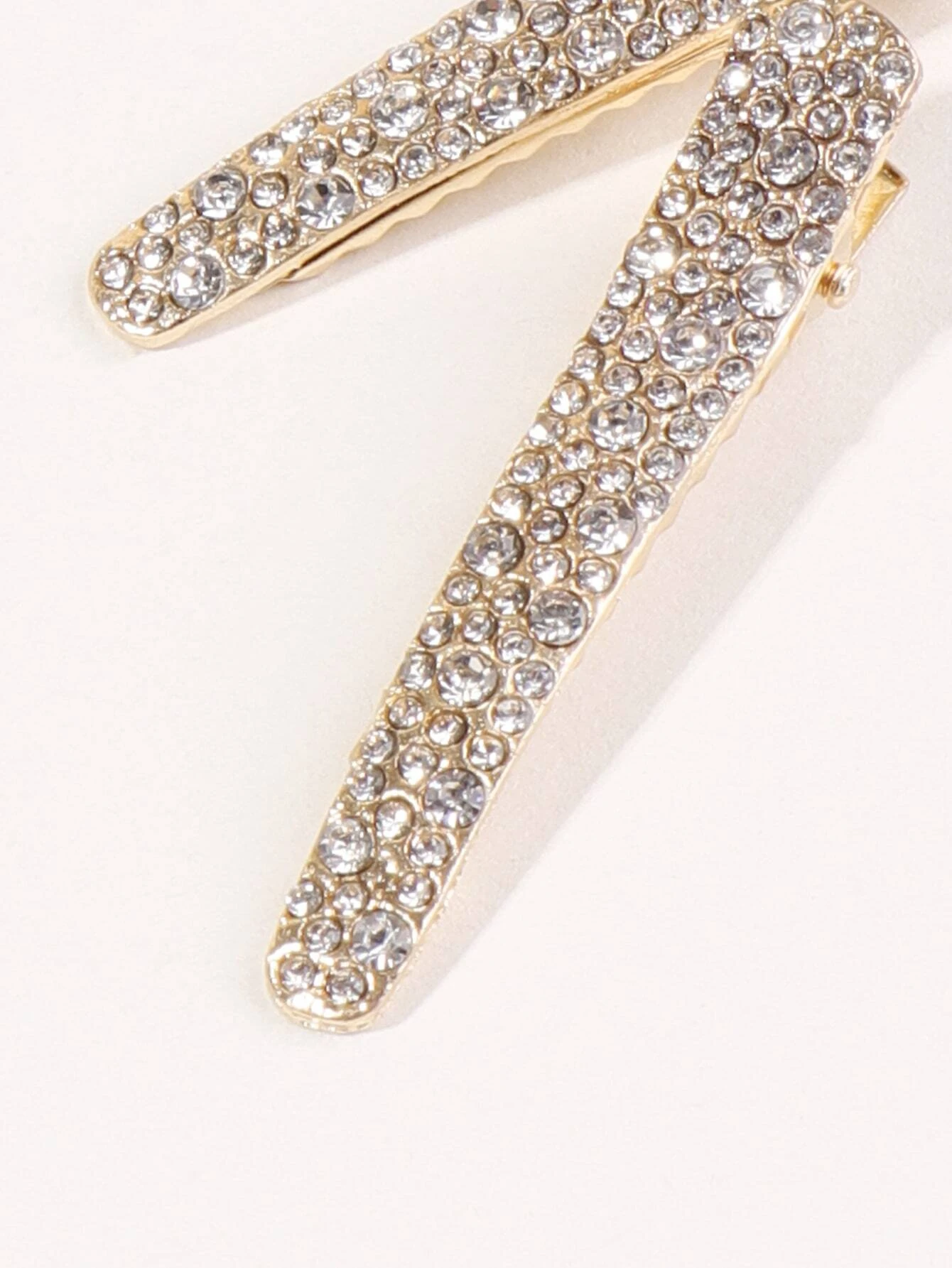 Two hair clips adorned with shimmering rhinestone decorations, adding a touch of elegance and glamour to your hairdo.
