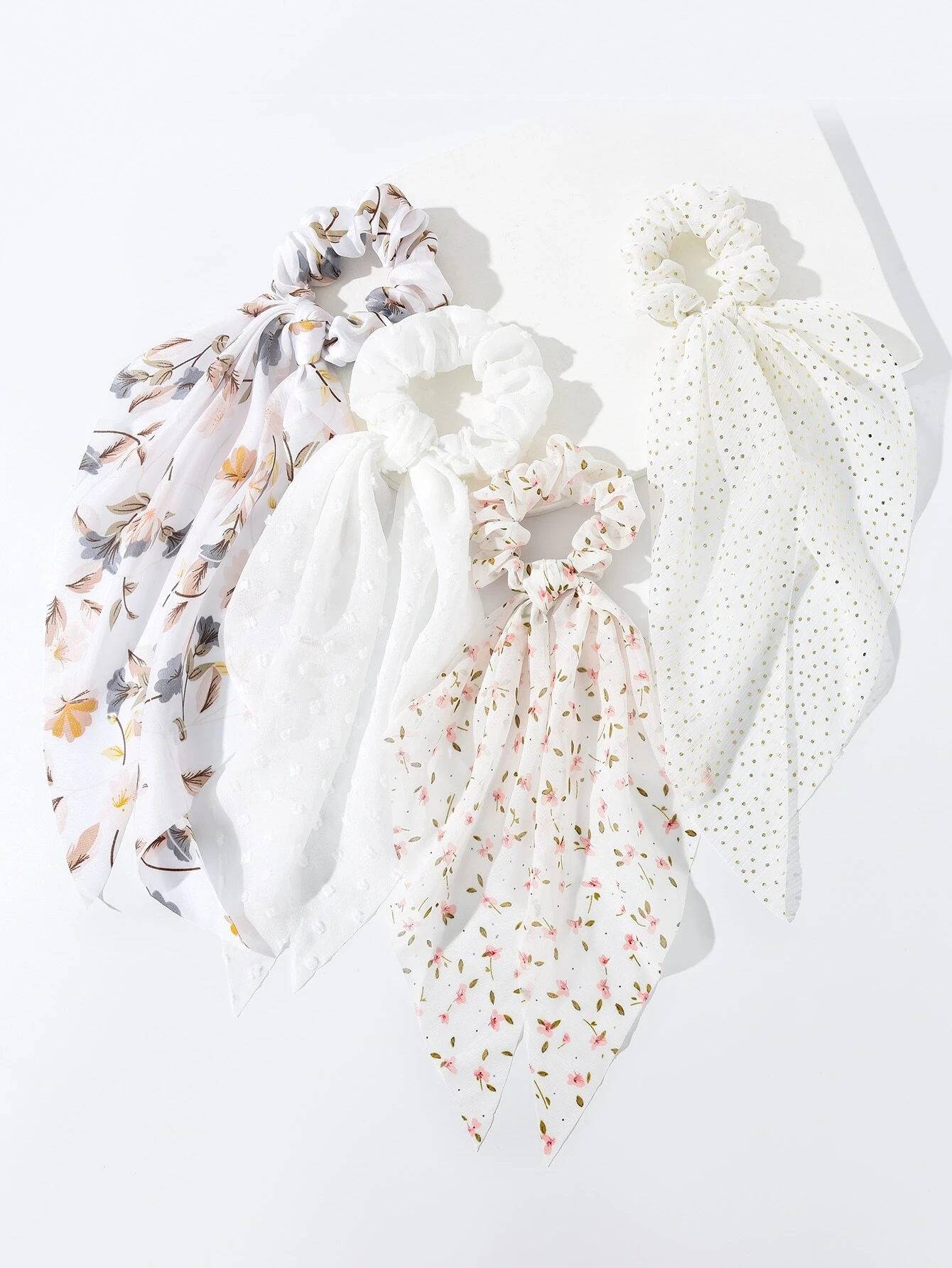 A set of four hair ties featuring floral print designs, adding a touch of nature-inspired charm to your hair accessories.