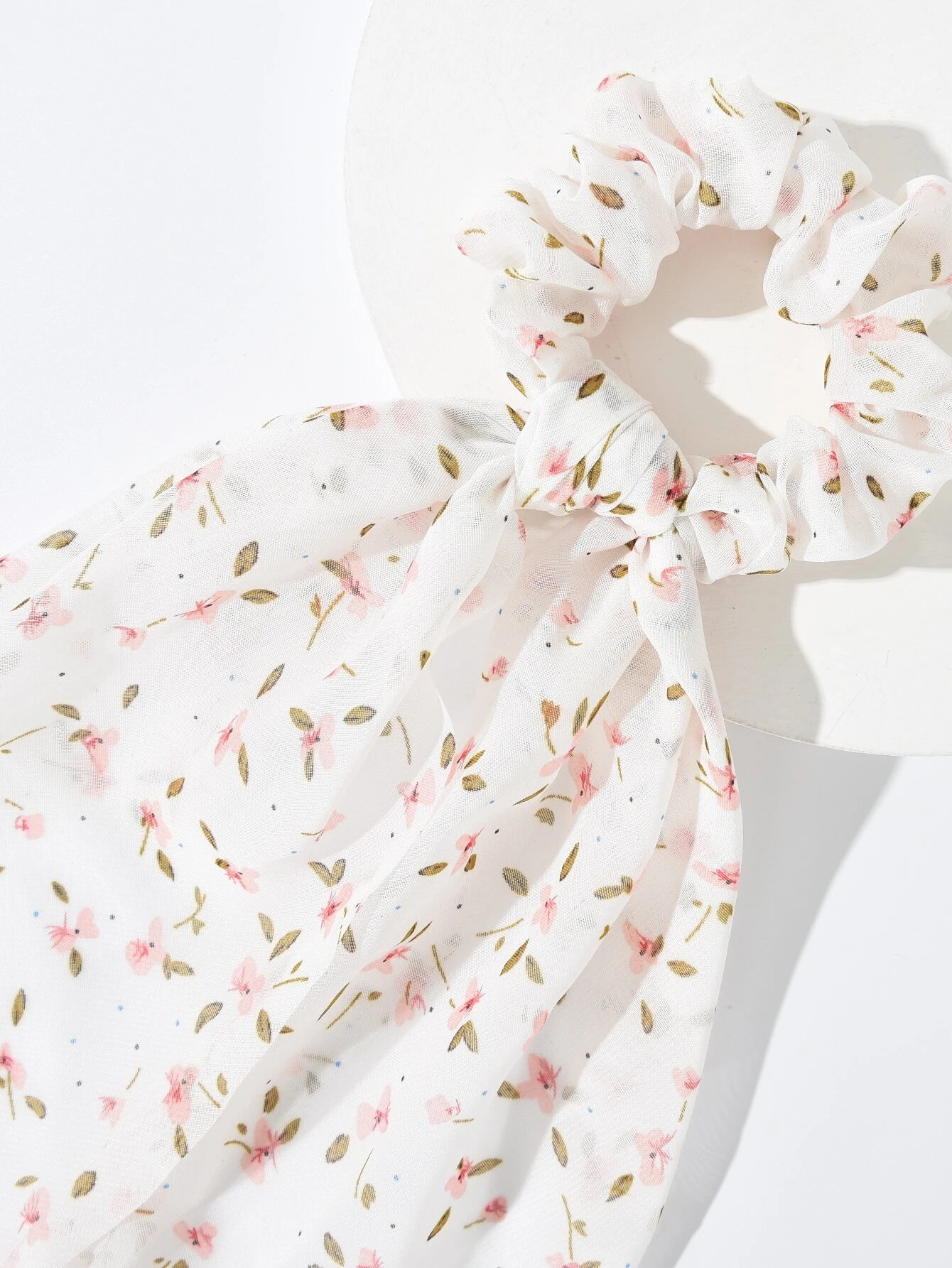 A set of four hair ties featuring floral print designs, adding a touch of nature-inspired charm to your hair accessories.