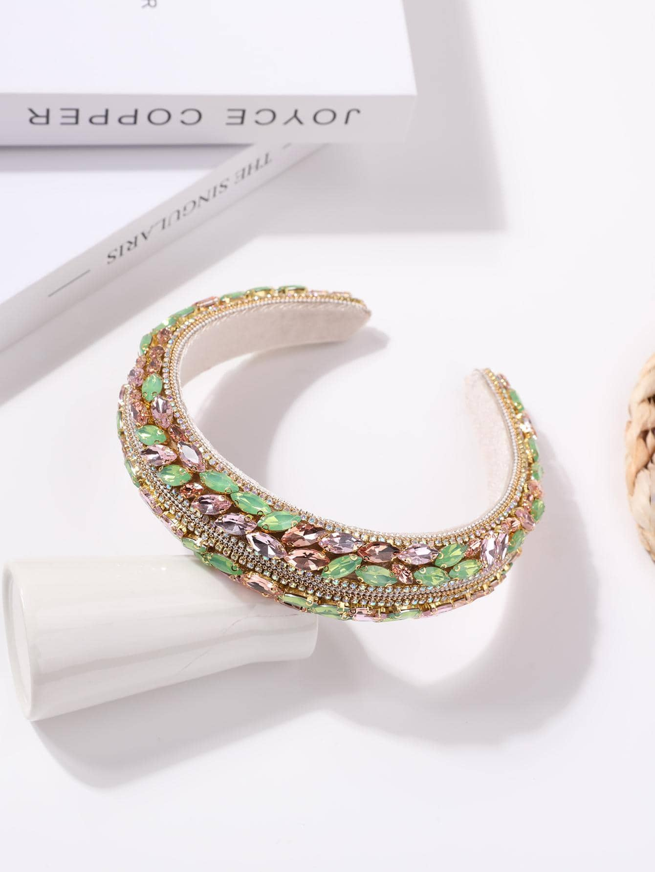 Glamorous headband adorned with green rhinestone decorations, adding a touch of elegance and sparkle to your hair accessory.