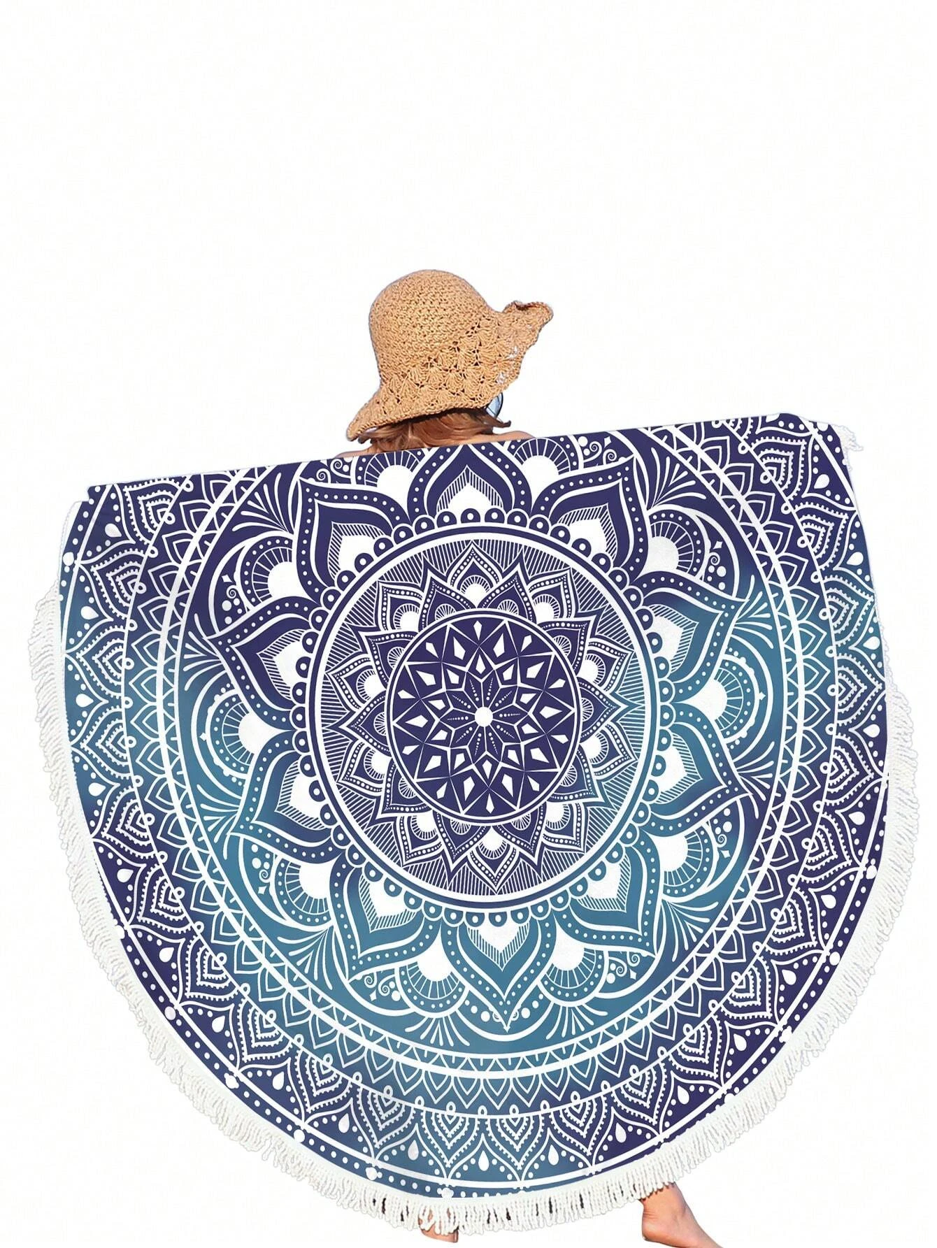 A boho beach towel with a blue ombre mandala print and fringe trim. The towel features a gradient of blue colors in a mandala pattern, with fringe trim along the edges. This towel is stylish and versatile, suitable for beach outings or outdoor relaxation. The blue ombre design and fringe trim add a touch of bohemian flair to the towel.