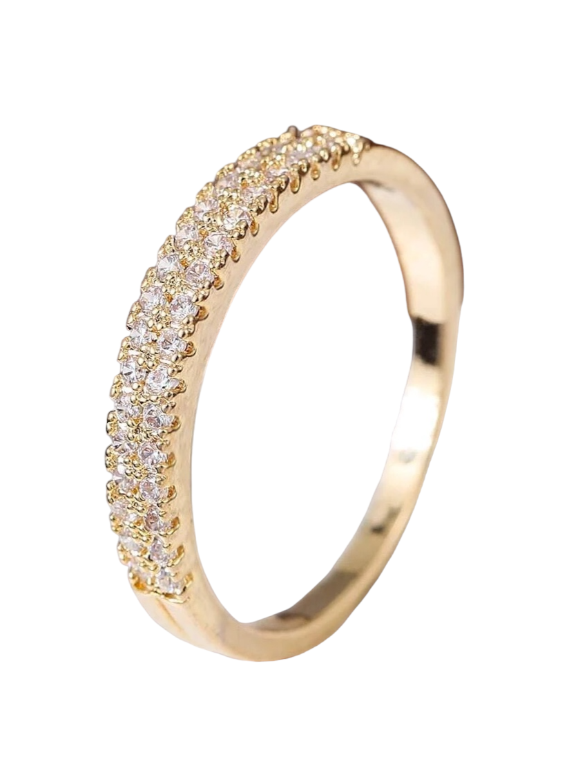 A dazzling gold ring adorned with cubic zirconia gems. The ring showcases brilliant cubic zirconia stones set within an elegantly designed gold setting. The sparkling gemstones and the lustrous gold combine to create a captivating and glamorous appearance. This ring is a stylish and sophisticated accessory that adds a touch of opulence and luxury to any outfit.