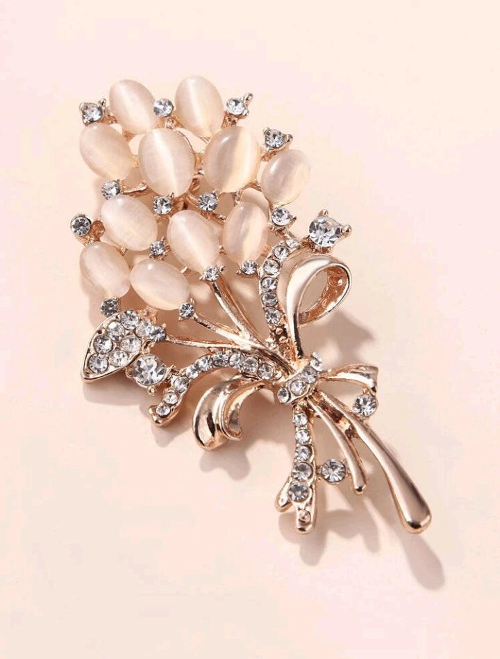 Brooch adorned with intricate rhinestone details, featuring a graceful rose design that adds a touch of elegance and sophistication to your ensemble.