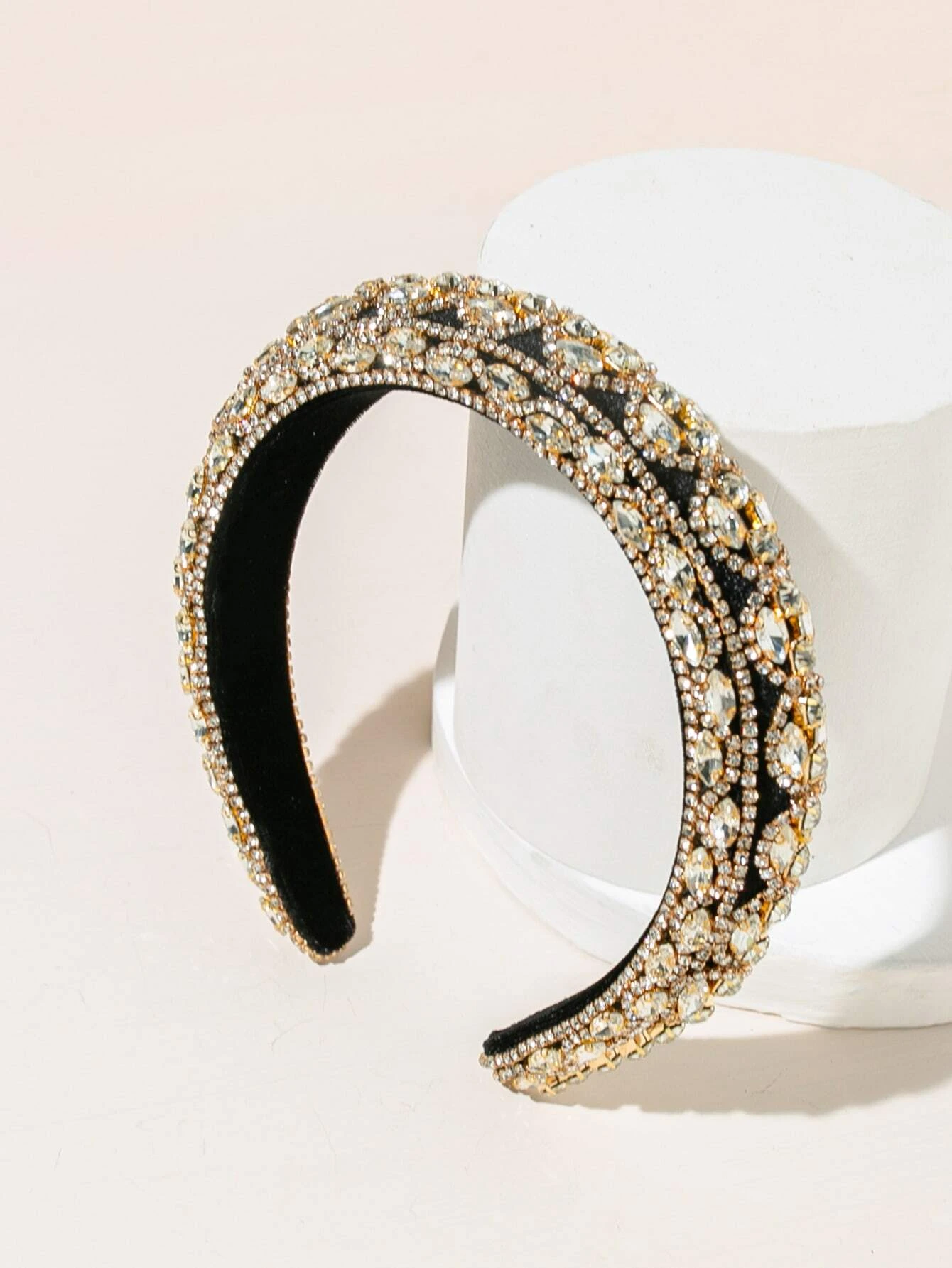 Headband adorned with rhinestones, providing a touch of elegance and sparkle to your hair look.