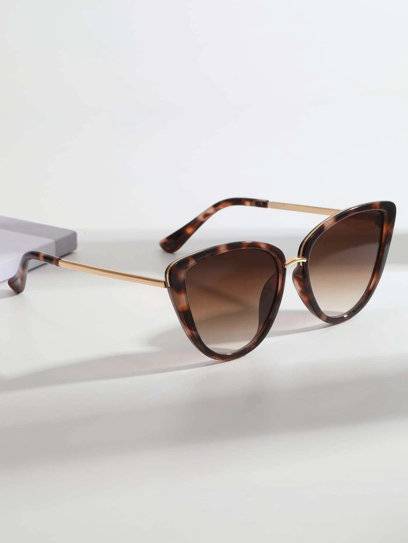 Pair of Cat Eye Tinted Lens Sunglasses with a stylish and bold design. These sunglasses showcase the iconic cat-eye frame shape and feature tinted lenses, providing both fashion and sun glare protection.