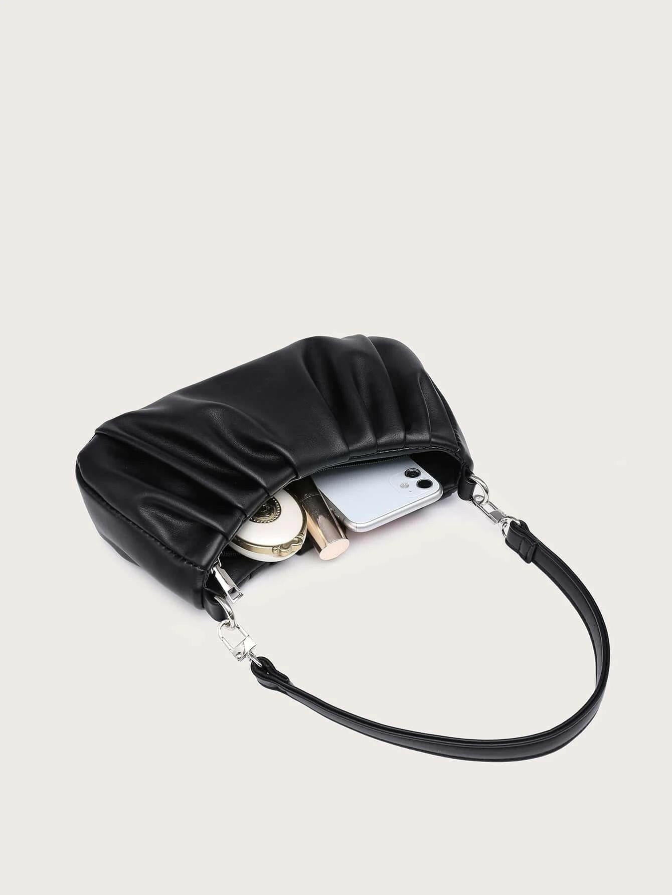 Shoulder bag with minimalist ruched design. This accessory offers a chic and stylish way to carry your essentials, combining modern simplicity with a touch of texture."