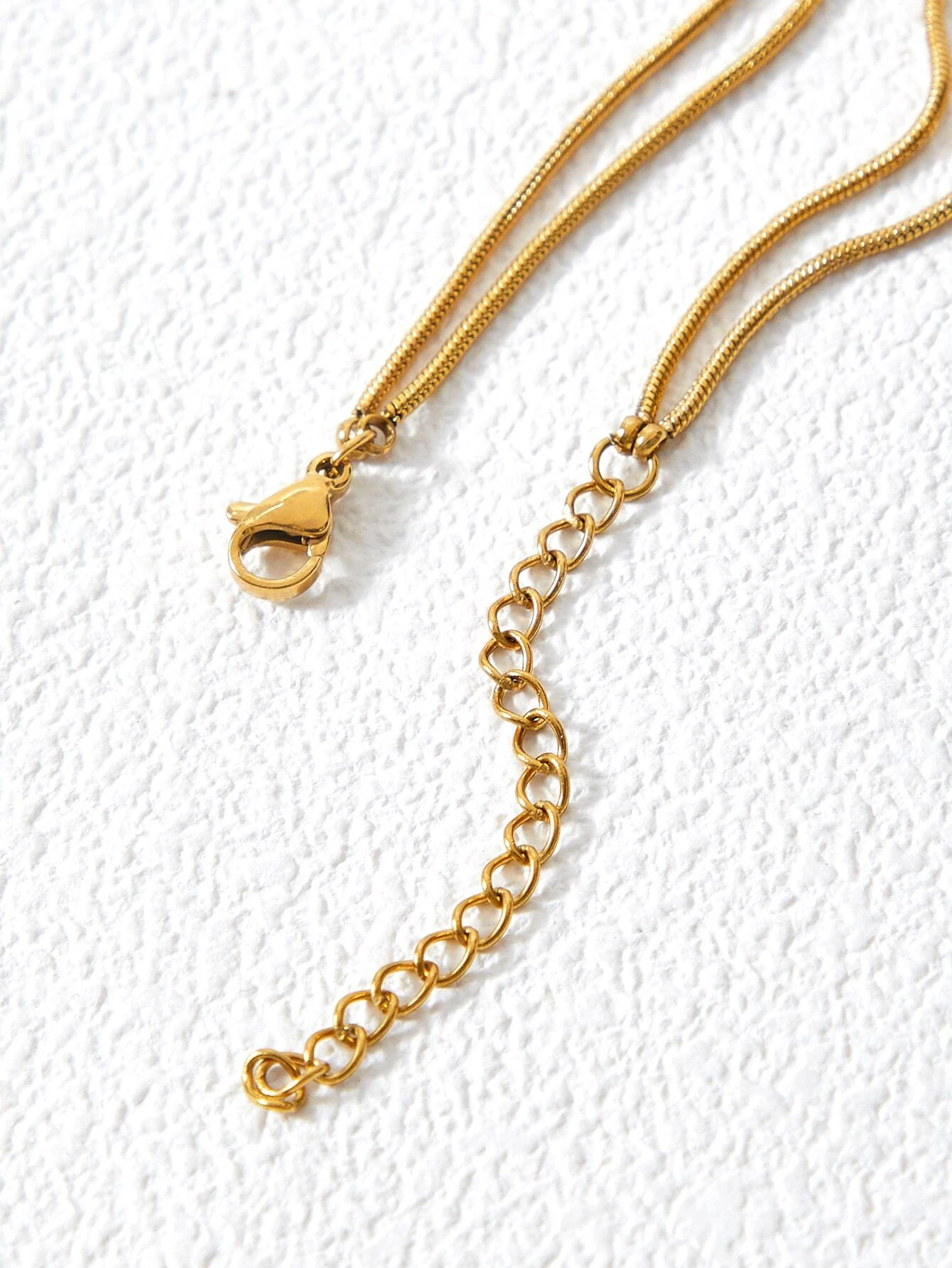 Layered necklace with round decorative elements. The necklace features multiple tiers of circular pendants in various sizes and textures, creating a visually dynamic and stylish piece. The interplay of metallic finishes and patterns adds depth to the design, making it a versatile and trendy accessory to elevate any outfit.