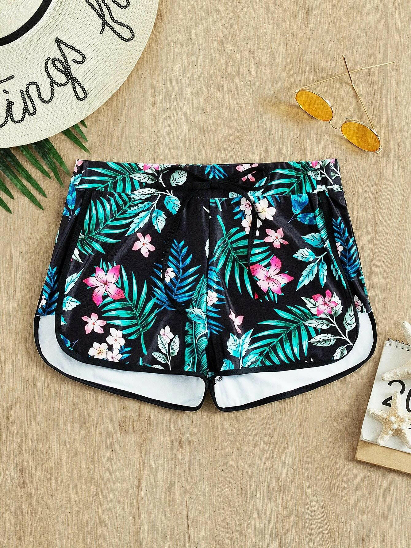 Tropical print swim shorts with vibrant and exotic patterns. These swim shorts showcase a lively tropical design, perfect for a beach or poolside vibe. The vibrant print adds a touch of color and energy to the swimwear, making them a stylish and eye-catching choice for water-related activities.