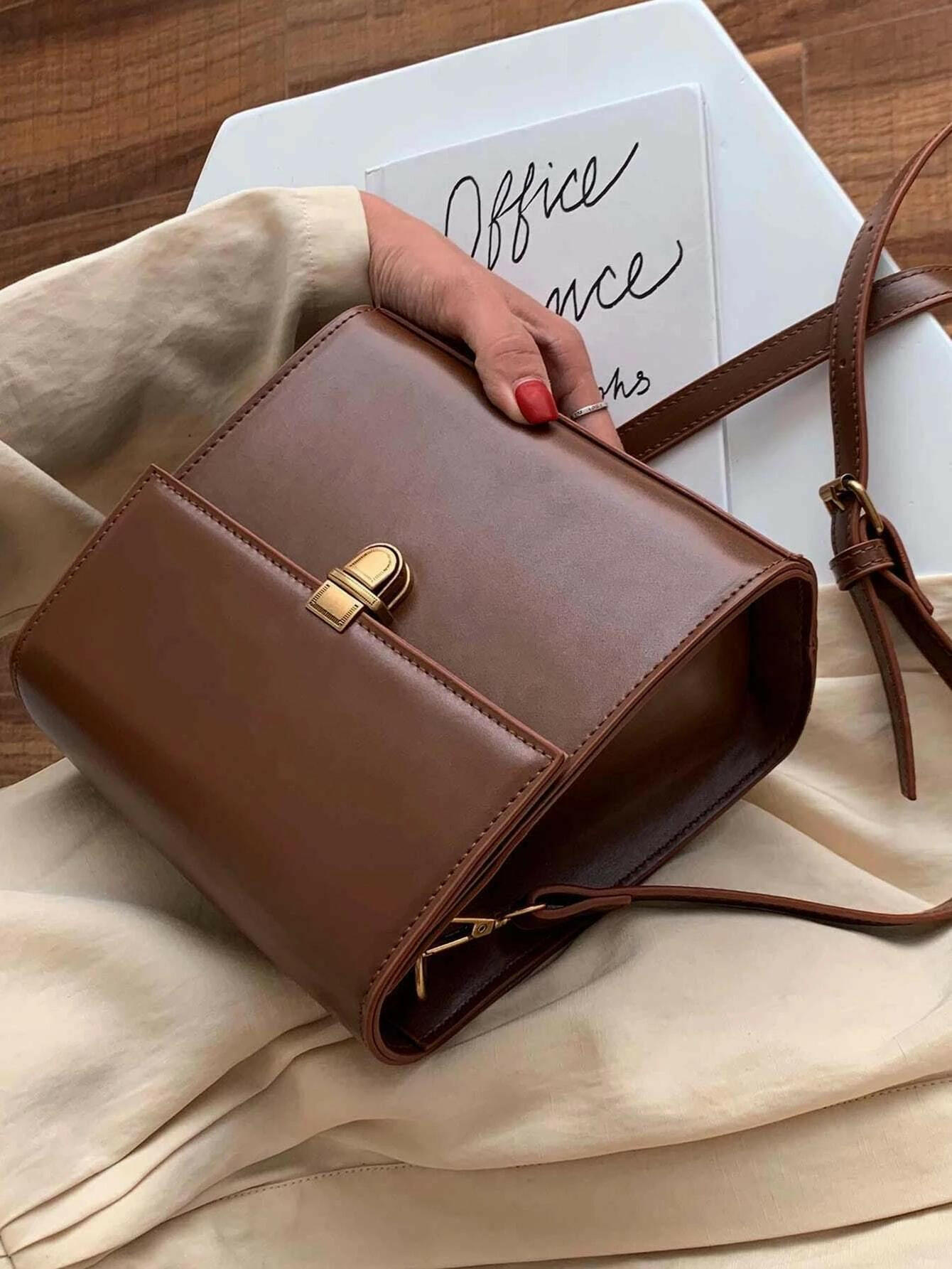 Push lock crossbody bag with minimalist design. This accessory combines practicality with clean lines, offering a sleek and versatile way to carry your essentials.