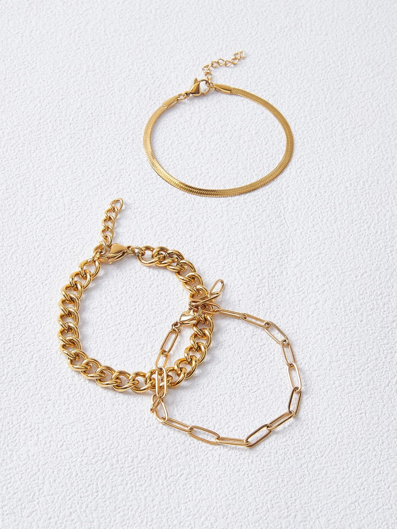 Set of three minimalist link bracelets, showcasing sleek and modern design. Each bracelet features clean, interlocking links, creating a chic and versatile accessory. The trio can be worn individually or stacked for a stylish layered look, suitable for both casual and dressier occasions.