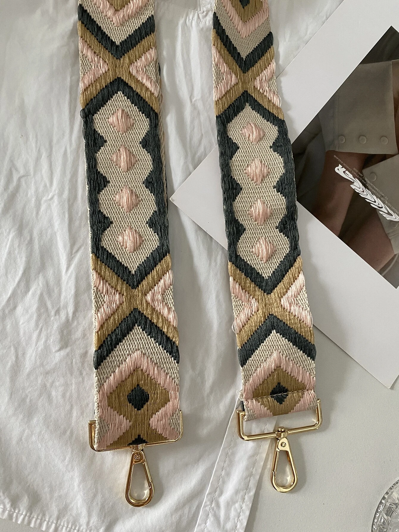 Bag strap adorned with intricate geometric embroidery. This accessory adds a touch of modern artistry and design, enhancing the visual appeal of your bag with its stylish geometric patterns.
