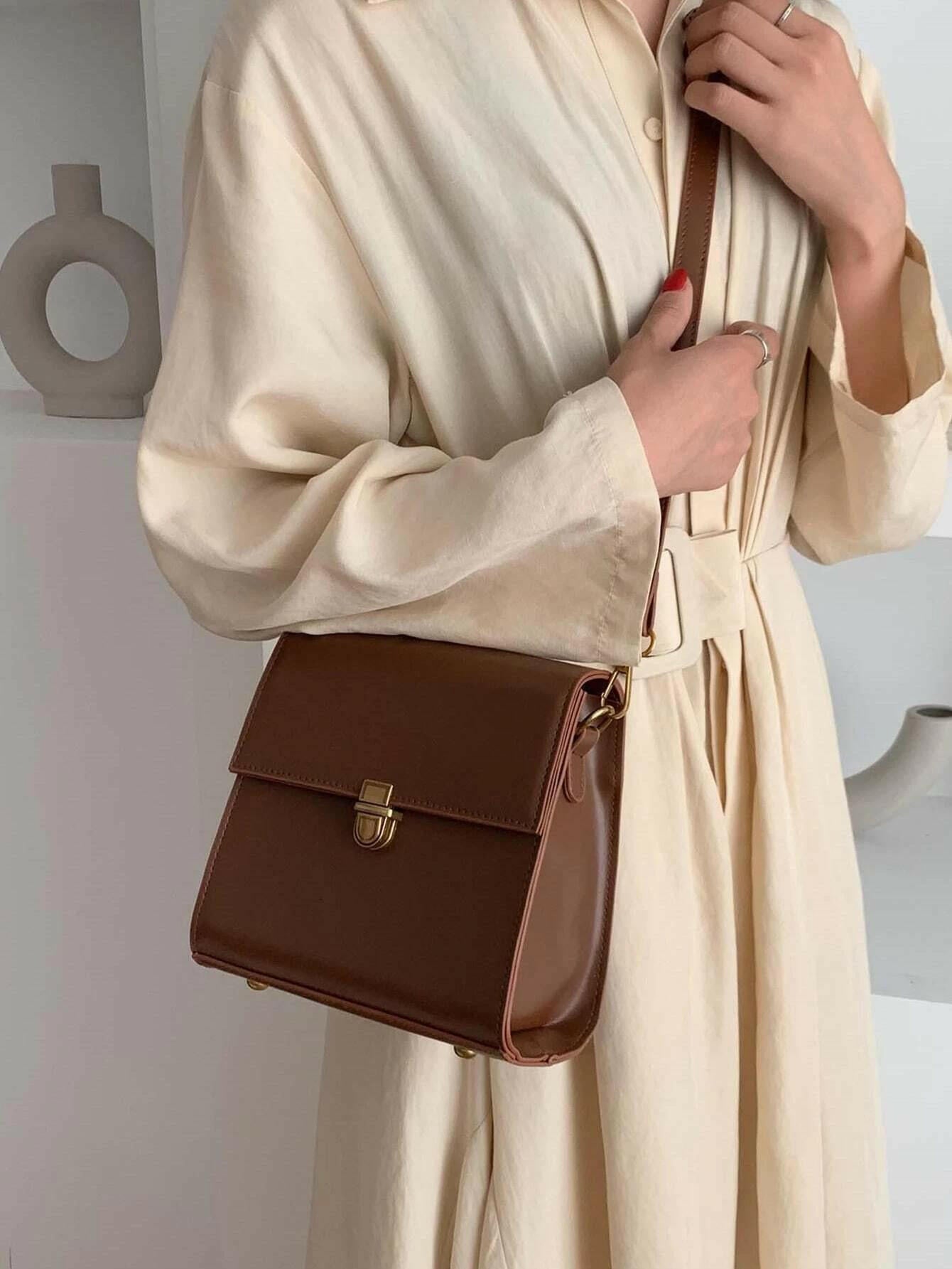 Push lock crossbody bag with minimalist design. This accessory combines practicality with clean lines, offering a sleek and versatile way to carry your essentials.
