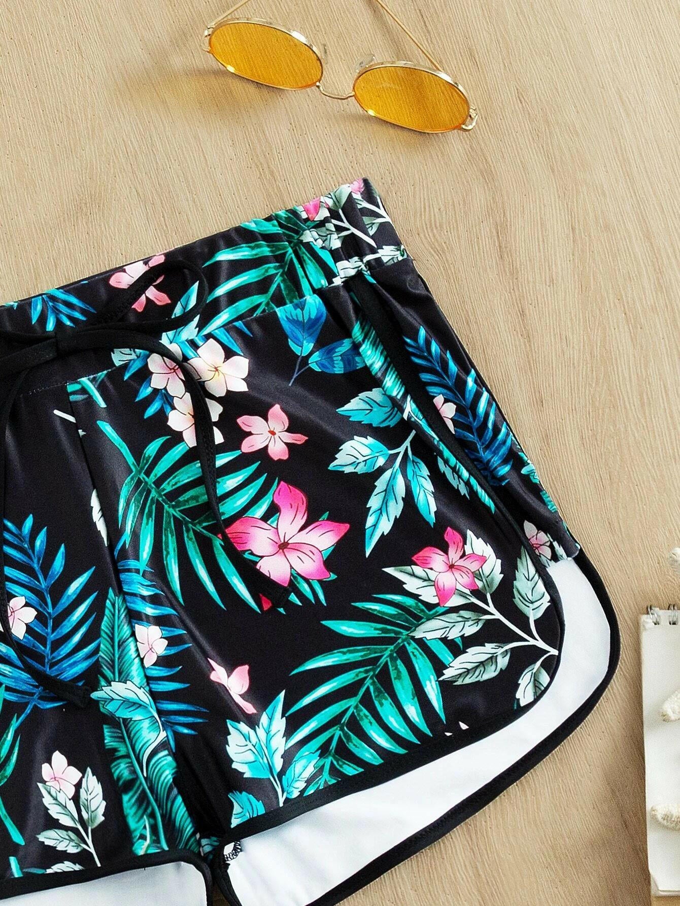 Tropical print swim shorts with vibrant and exotic patterns. These swim shorts showcase a lively tropical design, perfect for a beach or poolside vibe. The vibrant print adds a touch of color and energy to the swimwear, making them a stylish and eye-catching choice for water-related activities.