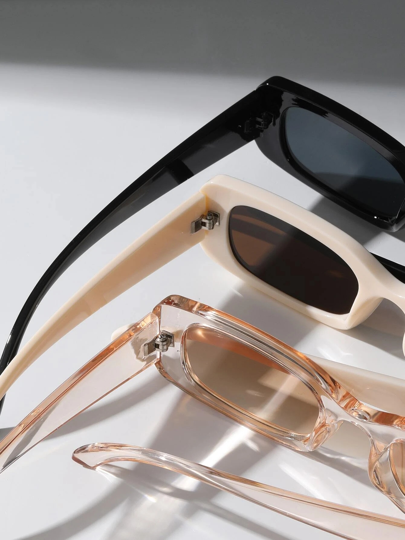 Three pairs of Square Frame Sunglasses featuring different color combinations. Square frames add a touch of boldness to your accessory collection while providing essential sun protection.
