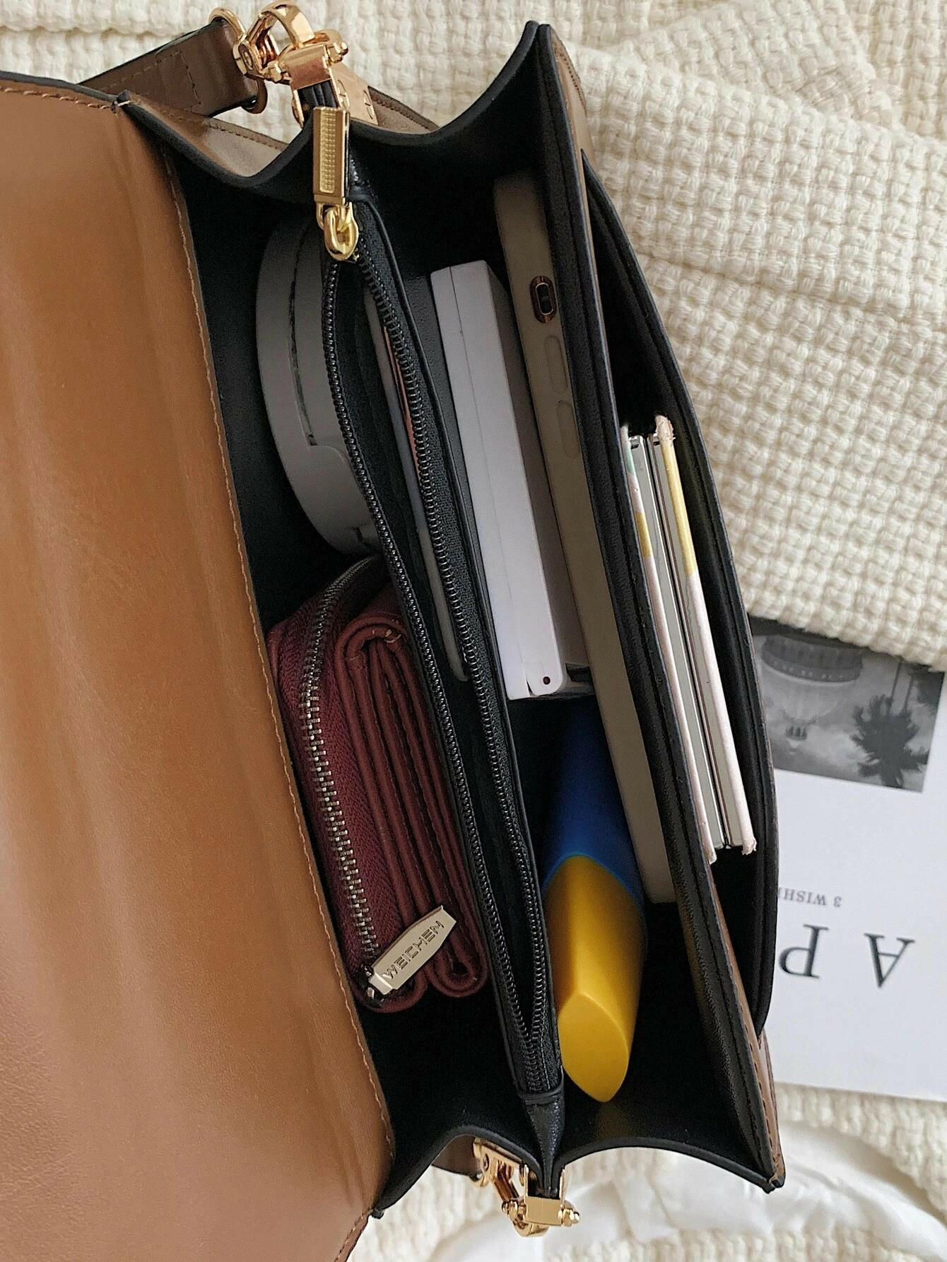 Square bag with flap closure and buckle decoration. This stylish accessory blends modern design with classic elements, offering both functionality and a fashionable touch.