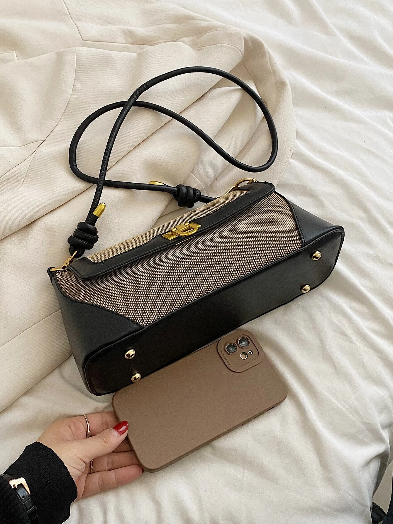 Two-tone flap baguette bag with a blend of colors. This accessory offers a sleek and stylish way to carry your essentials, embodying modern elegance and functionality.