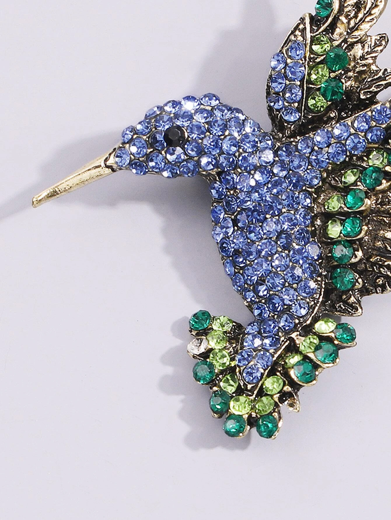 Brooch adorned with a bird design, embellished with sparkling rhinestones for a touch of elegance and nature-inspired beauty.