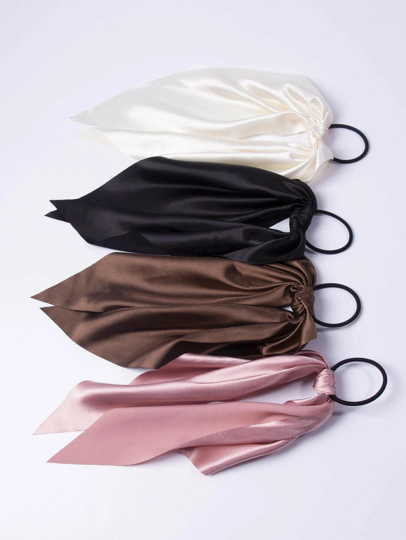 A collection of four knot-style hair ties, providing a simple yet fashionable way to secure and style your hair.