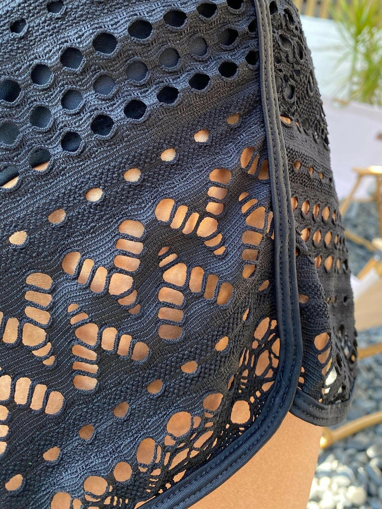 Black bikini shorts with stylish hollow-out detailing. These shorts showcase a chic and edgy design, featuring intricate hollow-out patterns against a black backdrop. The cut and style provide a comfortable and flattering fit, making them a trendy choice for swimwear. The hollow-out elements add a touch of flair to the classic black bikini shorts, perfect for a bold and fashionable beach or poolside statement.