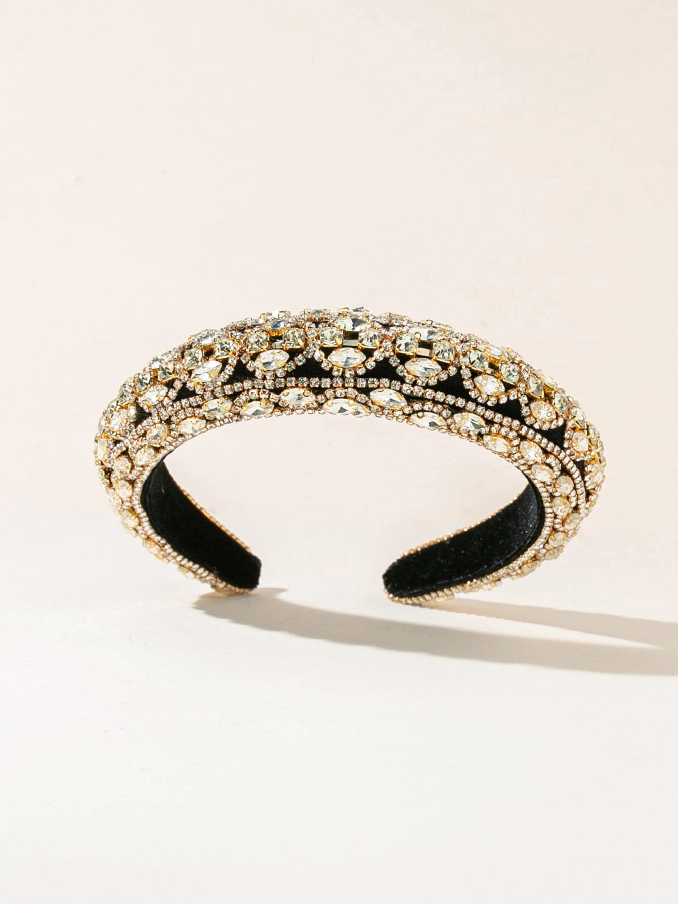 Headband adorned with rhinestones, providing a touch of elegance and sparkle to your hair look.