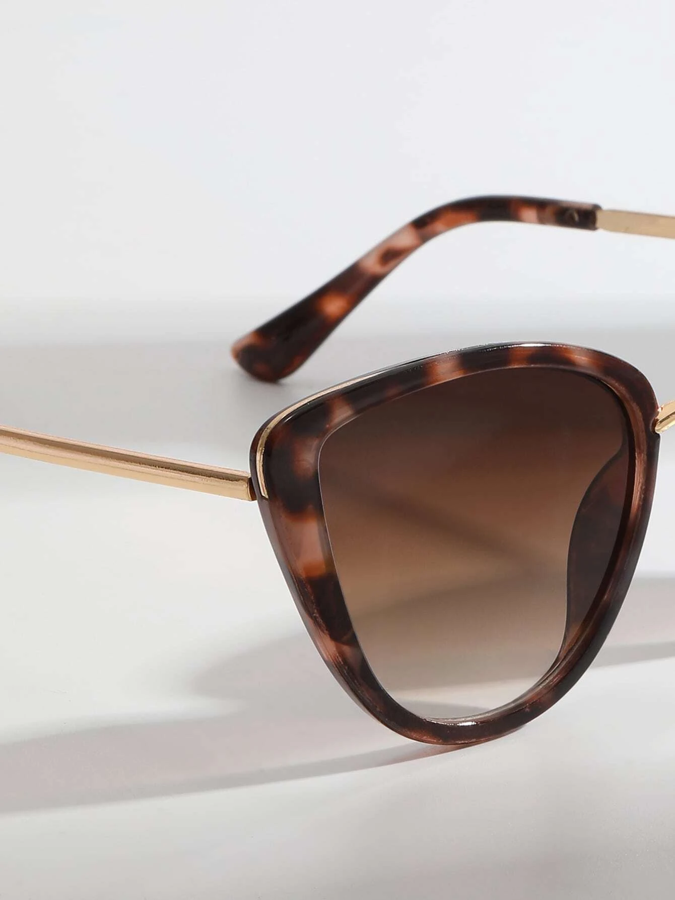 Pair of Cat Eye Tinted Lens Sunglasses with a stylish and bold design. These sunglasses showcase the iconic cat-eye frame shape and feature tinted lenses, providing both fashion and sun glare protection.