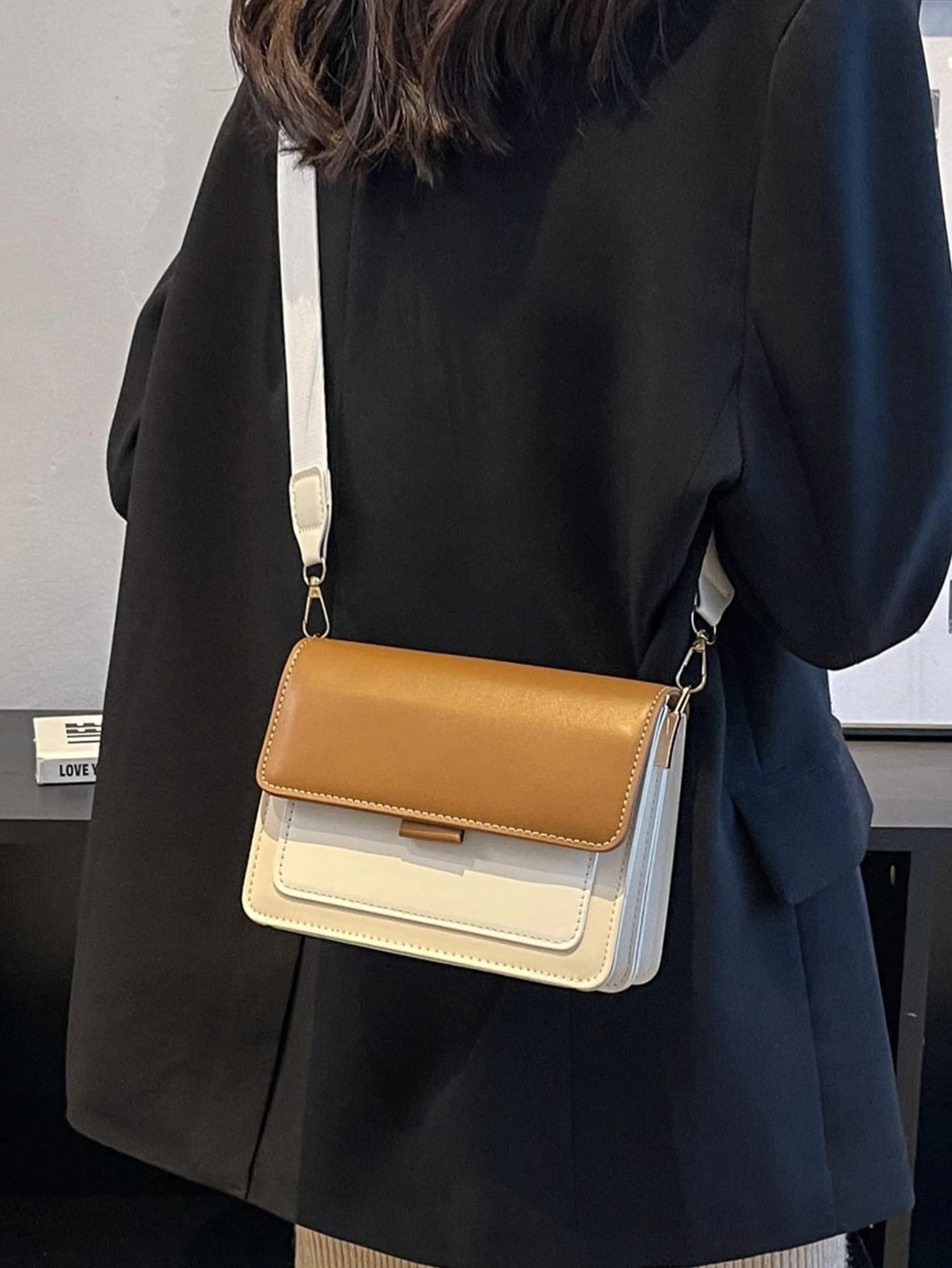 Mini square bag with color block flap design. This accessory combines modern design with vibrant color contrasts, offering a chic and stylish way to carry your essentials.