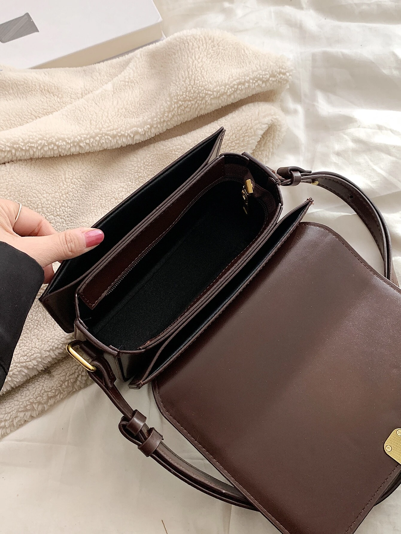 Square bag with twist lock flap closure. This accessory offers a chic and stylish way to carry your essentials, featuring a secure twist lock that enhances its functionality.